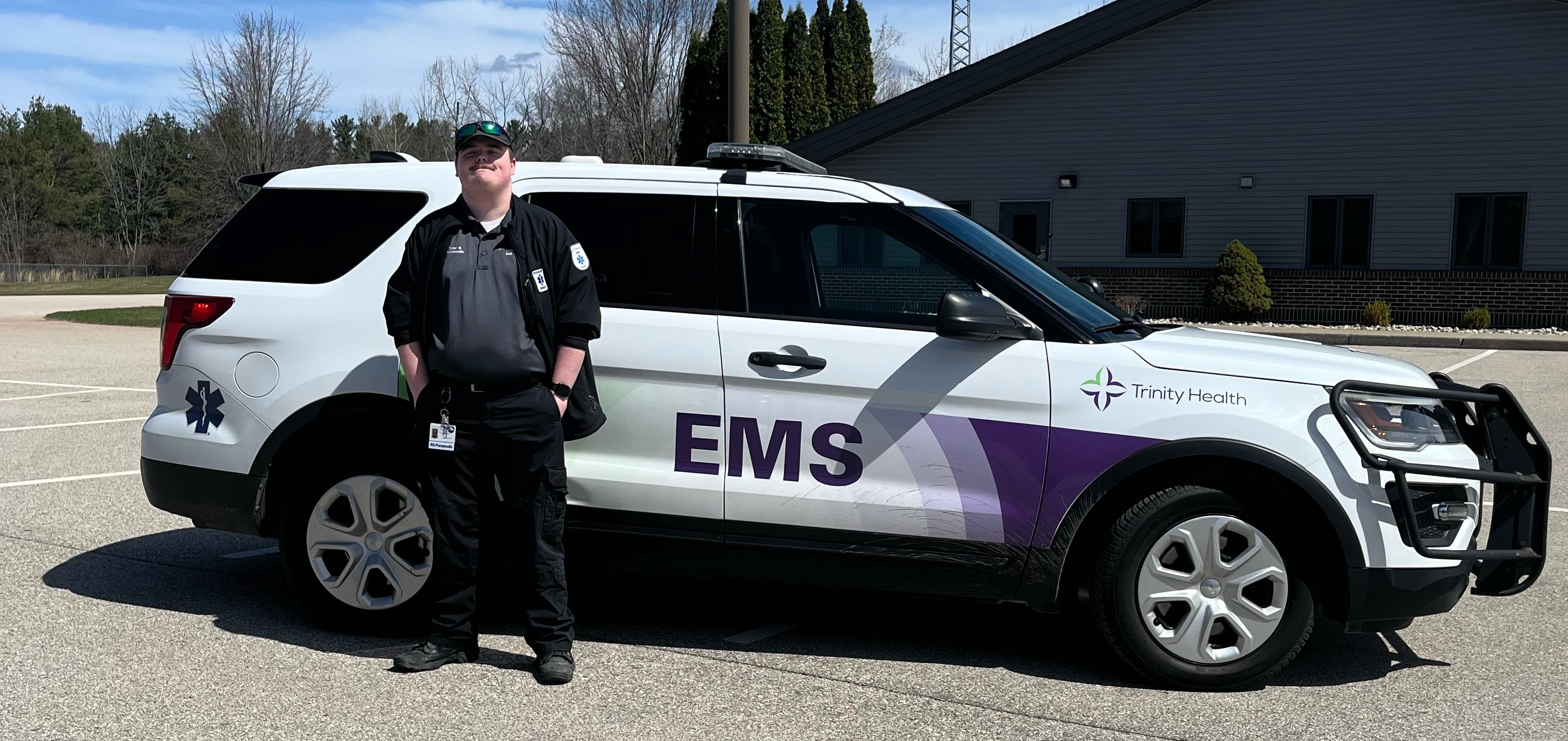 Tyler in front of EMS SUV
