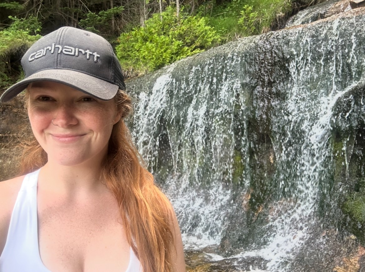 Keauna standing next to a waterfall