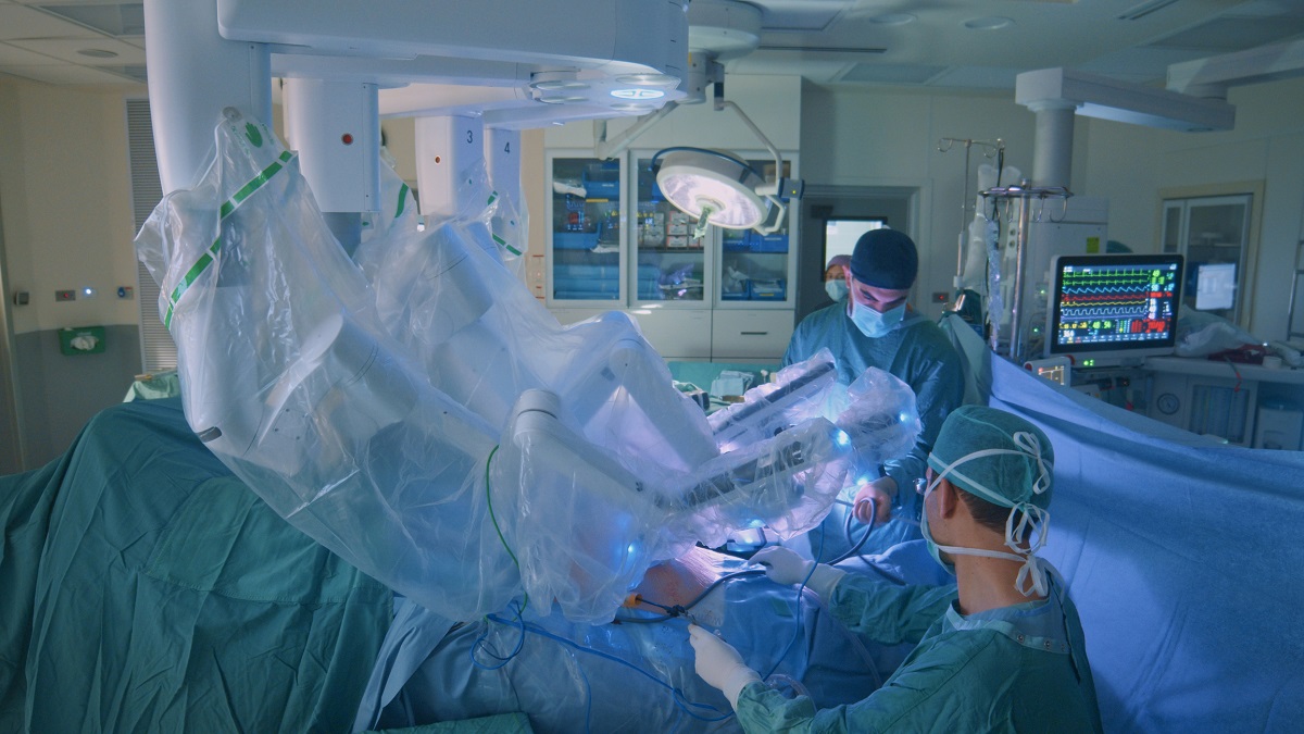 Surgeon doing laparoscopic surgery in hospital with a medical robot.