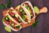 Healthy Vegan Tempeh Tacos. Serving Board, Above View On A Dark Wood Background.