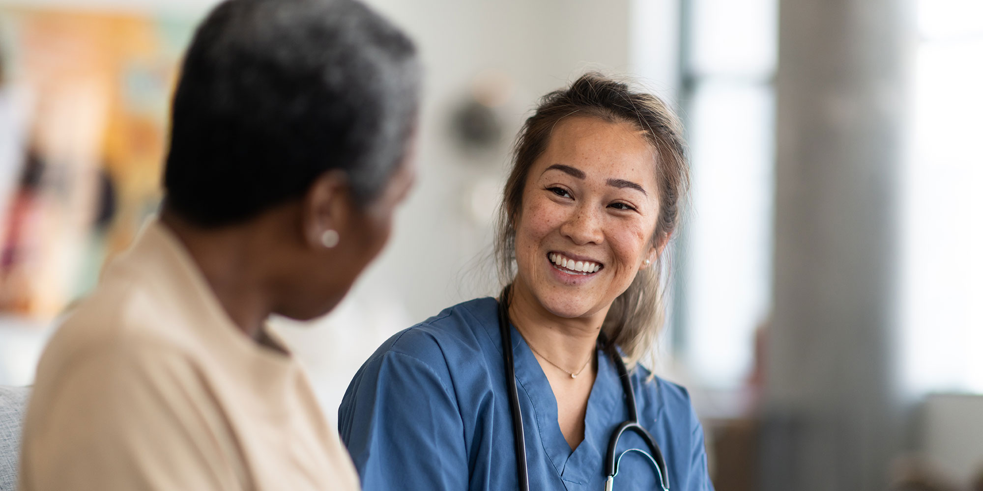 A doctor meets with a patient in the hospital to discuss a treatment plan